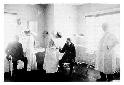 Dr. Joseph P. Ritenour. with nurses and patients in the infirmary