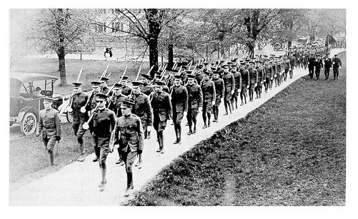 old black and while photgraph of students marching in military uniforms