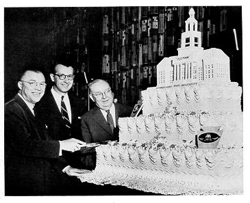 old black and white photograph of Milton Eisenhower, Governor George Leader, and James Milholland posed with the Penn State birthday cake